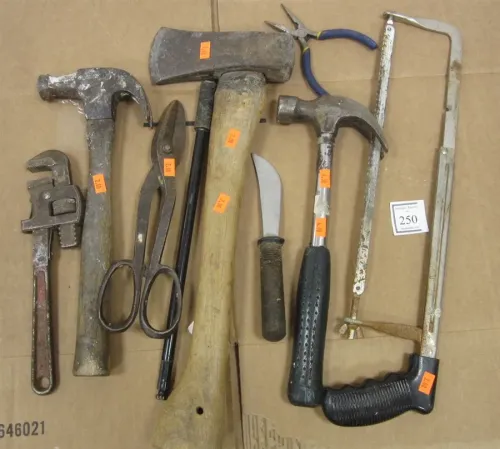 BOX OF TOOLS INCLUDING HAMMERS, PIPE WRENCH, HACHET, TIN SNIPS AND MORE