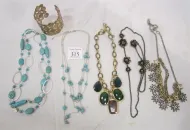 FIVE COSTUME NECKLACES AND ONE METAL BRACELET