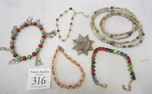 COSTUME JEWELRY: NECKLACE, FOUR BRACELETS AND SKI PIN